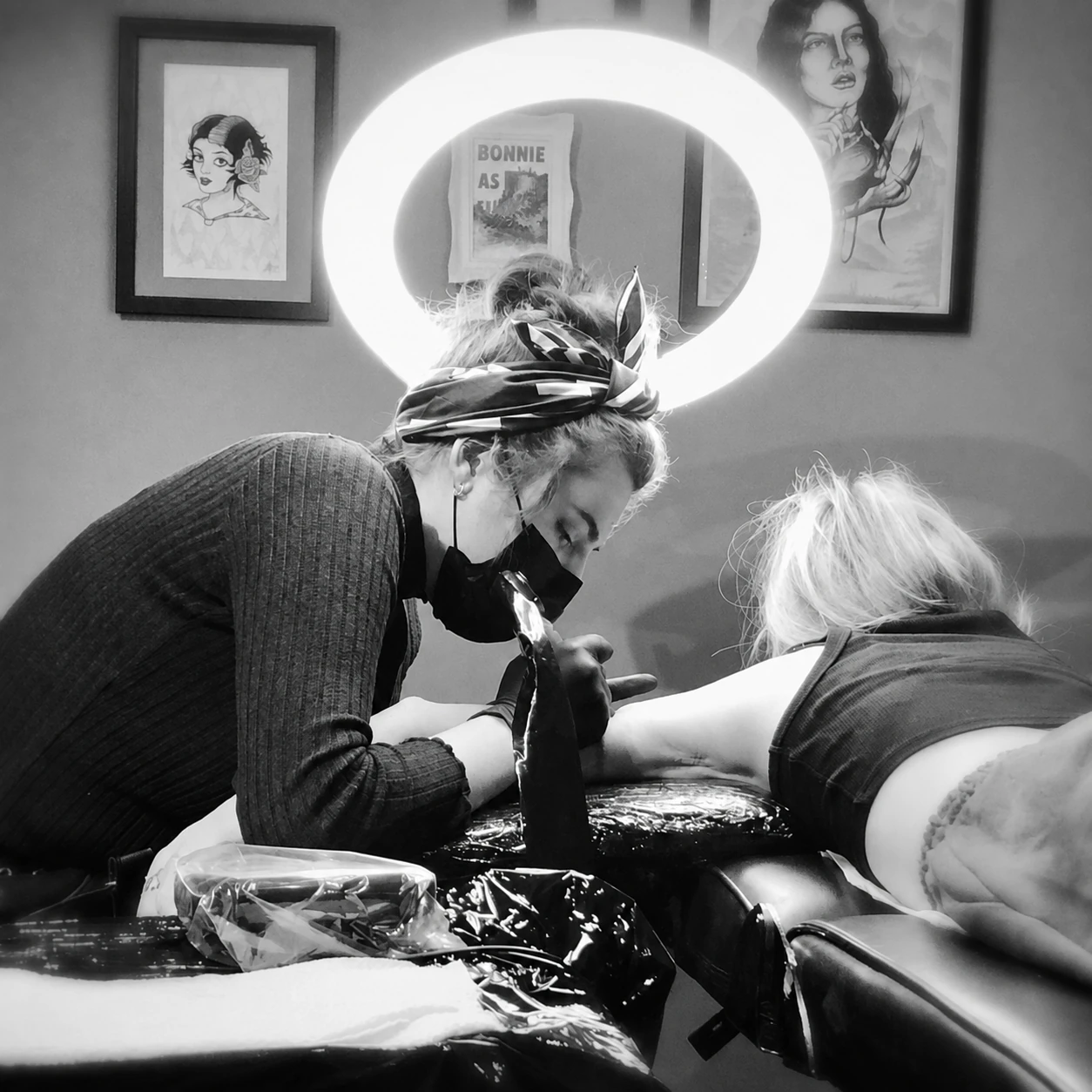 Alexa tattooing a client in the studio